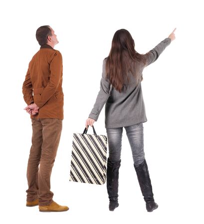 back view of couple with shopping bags in winter jacket. backside view of person. Rear view people collection. Isolated over white background.の写真素材