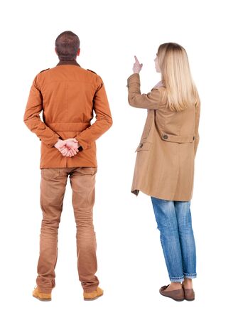 Back view of two pointing girl in winter jacket. Rear view people collection. backside view of person. beautiful woman friends showing gesture. Rear view. Isolated over white background.の写真素材