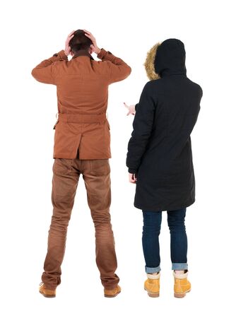 Back view of two pointing girl in winter jacket. Rear view people collection. backside view of person. beautiful woman friends showing gesture. Rear view. Isolated over white background.の写真素材