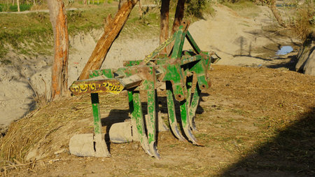 Old green plow on the ground in the countryside, Thailand.の写真素材