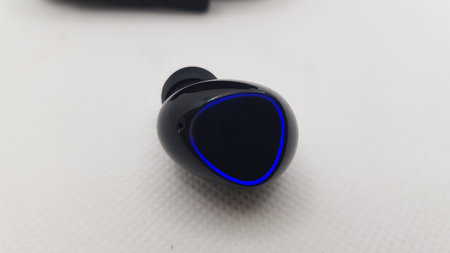 Close-up of a wireless earphones on a white background.