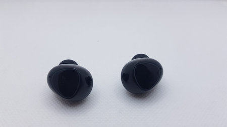 Black earphones on white background. Shallow depth of field.