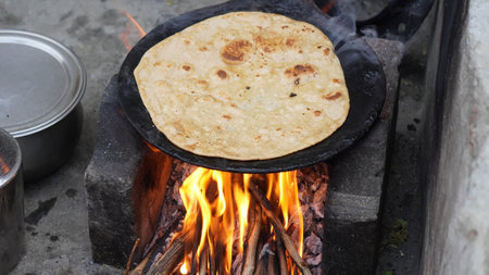 Grilled flatbread on a fire in the village. Close-up.の写真素材