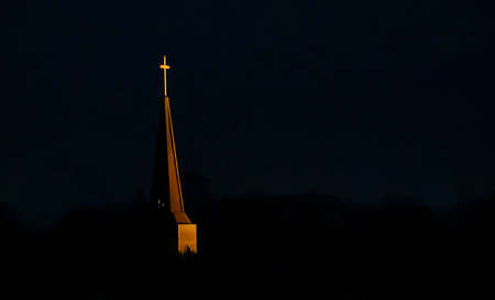 Light falling on the cross of the church symbolizing HOPE.の写真素材
