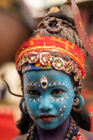 Rajasthan, India - November 9, 2019: A portrait of a poor kid dressed as lord Shiva in Pushkar Fairのeditorial素材