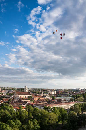 view of Vilnius with some hot air balloon in the skyの写真素材