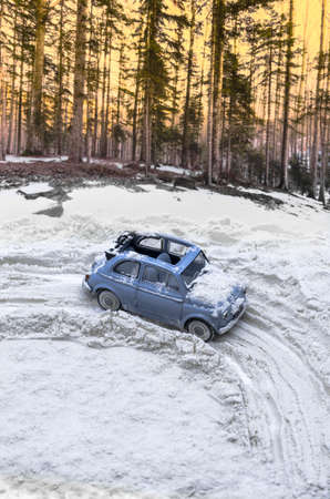 Vintage car on snow-covered mountain road