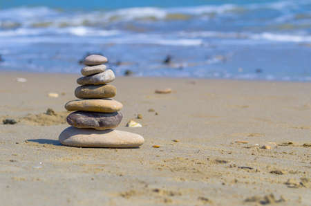 Zen stones balanced on the beachの写真素材