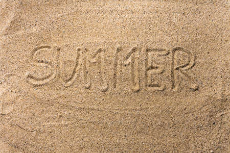 Background with text "summer" written in the sandの写真素材