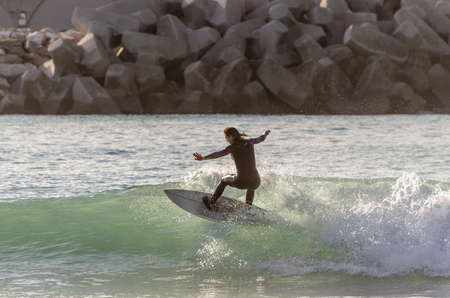 Surfer riding the waves of the sea