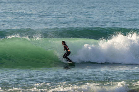 Surfer riding the waves of the sea
