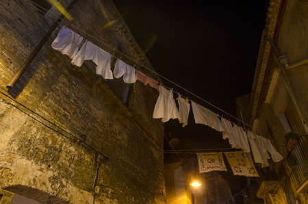 Typical view of a country lane in southern Italy with laundry hanging out to dryの写真素材