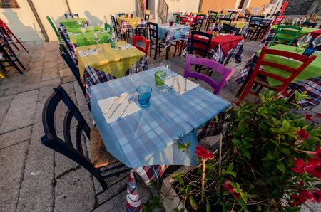 View of the tables set on the street of an outdoor restaurantの写真素材