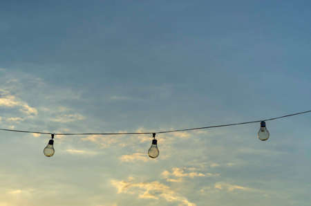 Row of light bulbs hanging outdoors