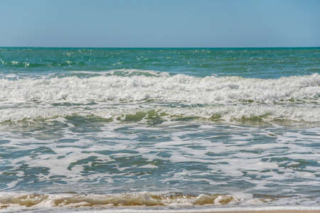 Sea with waves in the foreground on the shoreline