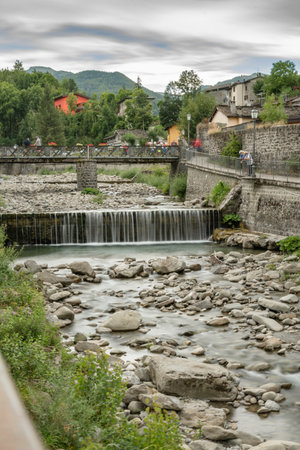 Mountain village with river and vegetationの写真素材