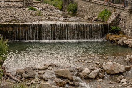 Countryside landscape with river and small waterfall