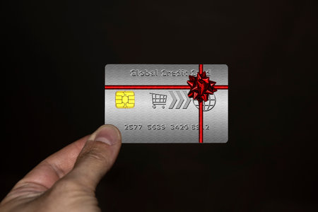 Hand holding a credit card with ribbon and cockadeの写真素材