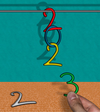 2023 with hanging numbers with hand changing last digit of the yearの写真素材