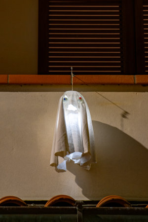 Ghost hanging on the window for Halloweenの写真素材