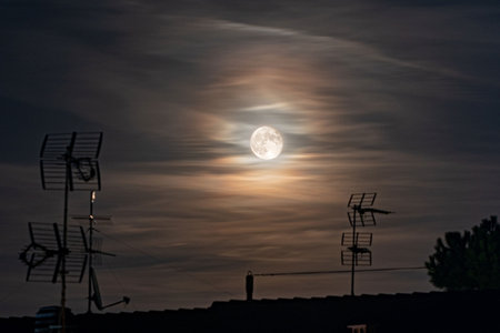 Beautiful cloudy sky with shining full moonの写真素材