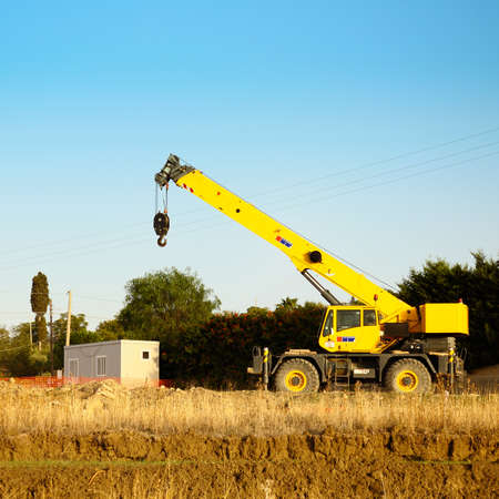 Mobile cranes at a construction site near a prefabricated Featured you can see the excavated earthの写真素材