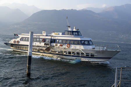 Hydrofoil on the lake slows to dock, mountains backgroundの写真素材