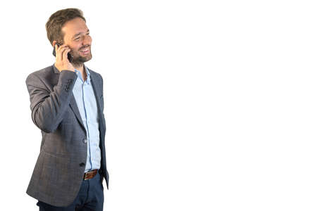 Handsome middle-aged businessman, wearing suit, making a phone call. White background. Copyspace.の写真素材