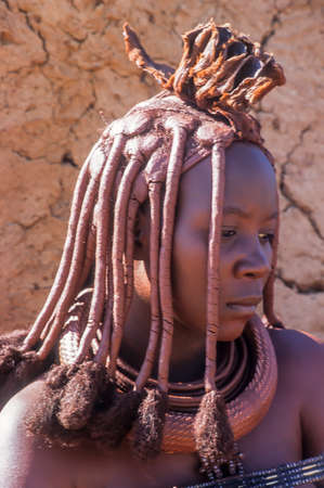 May 15, 2005. portrait of unidentified Himba woman with traditional hairstyle, necklace and the...