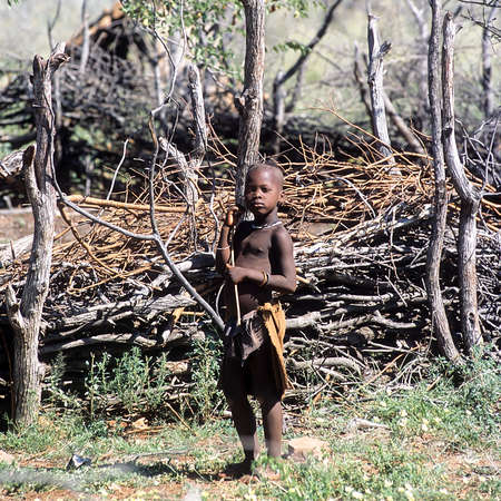 May 15, 2005.Himba village. unidentified Himba boy near the kraal. Epupa Falls, Kaokoland or Kunene Province, Namibia, Africaのeditorial素材