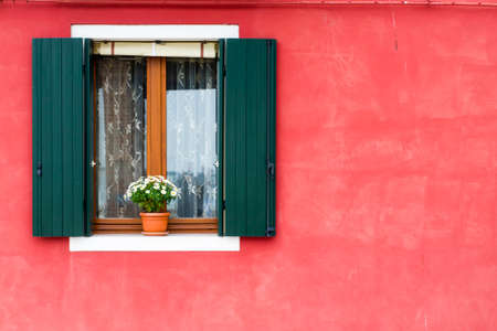 A window of one of the characteristic colored houses of Burano (Venice)
