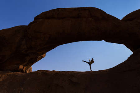 karate kick silhouette Within an eye formed by the stoneの写真素材