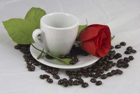 white cup of coffee and red roseの写真素材