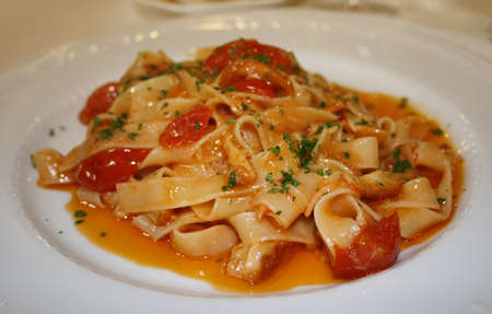noodles with sauce and cherry tomatoesの写真素材