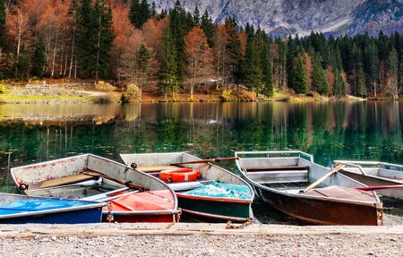 Alpine landscape and colorful boats, Lake Fusine, Italy
