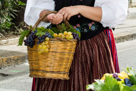 QUARTU SE, ITALY - SEPTEMBER 21, 2014: Parade of Sardinian costumes and carts for the grape festival in honor of the festivities of Sant'Elena - Sardiniaのeditorial素材