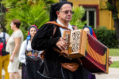 SELARGIUS, ITALY - SEPTEMBER 13, 2015: Ancient Selargino wedding, musician parading in traditional Sardinian costume - Sardiniaのeditorial素材