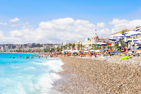 NICE, FRANCE - AUGUST 23: Tourists enjoy the good weather at the beach on August 23, 2015 in Nice, France. The beach and the waterfront avenue, Promenade des Anglais, are full almost all the year.のeditorial素材