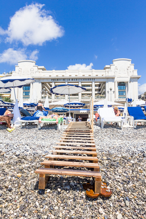 NICE, FRANCE - AUGUST 23: Tourists enjoy the good weather at the beach on August 23, 2015 in Nice, France. The beach and the waterfront avenue, Promenade des Anglais, are full almost all the year.のeditorial素材