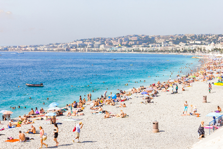 Tourists enjoy the good weather at the beach in Nice, Franceのeditorial素材
