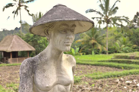 Statue of a worked in a coffee plantation in Ubud, Bali, Indonesiaのeditorial素材