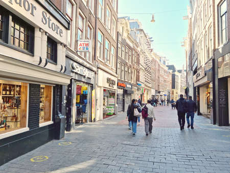 Amsterdam, The Netherlands - 04 October, 2021: People walking in the Nieuwendijk street. The street runs north-south, connecting the Central Station and the Dam square.のeditorial素材
