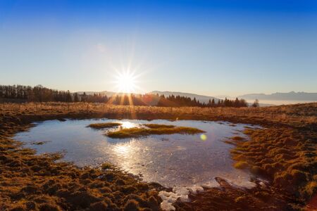Cansiglio, Veneto, Italy; 2016 - 12 30: sunset and icy puddleのeditorial素材