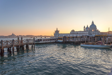 VENICE, ITALY - JANUARY 02 2018: vaporetto terminal  at sunset in front of Basilica della Salute. The vaporetto is the public means par excellence of the cityのeditorial素材