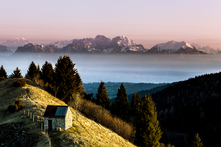 Sunrise on a solitary hut with in the background the dolomite peaks, Pian de le Femene, Veneto, Italyの写真素材