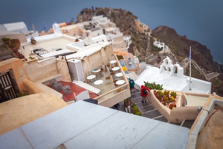 Tilt shift effect of terraces and houses of Oia on rainy dayの写真素材