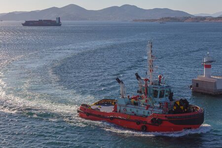 Tugboat at the entrance to the port of Piraeus, Athens