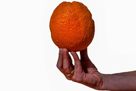hand holding an orange on a white backgroundの写真素材
