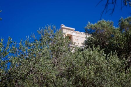 Tilt shift effect of trees surrounding Acropolis with Temple of Athena Nike