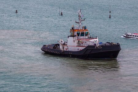 Tugboat working in the port of Venice